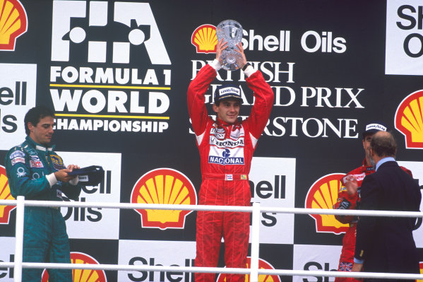 Silverstone, England. 8th - 10th July 1988.Ayrton Senna (McLaren MP4/4 Honda), 1st position with  Nigel Mansell (Williams Judd) 2nd position and Alessandro Nannini (Benetton Ford) 3rd position celebrate on the podium. World Copyright - LAT Photographic.Ref: 88GB21.