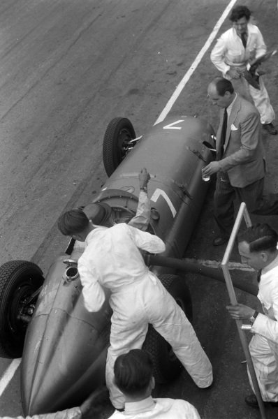 Peter Walker, BRM P15, reaches out for a drink as a mechanic prepares to refuel his car during a pitstop. Peter Walker, BRM P15, reaches out for a drink as a mechanic prepares to refuel his car during a pitstop.