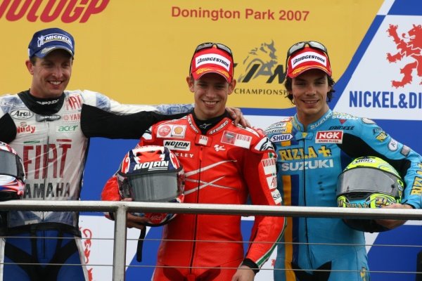 2007 Moto GP British Grand Prix.
Donington Park, England.
22nd-24th June 2007.
Casey Stoner (Ducati Marlboro Team, Ducati Desmosedici GP7, 1st position), Colin Edwards (FIAT Yamaha Team, Yamaha YZR-M1, 2nd position) and Chris Vermeulen (Rizla Suzuki Moto GP, Suzuki GSV-R XRG0, 3rd position) celebrate on the podium, portrait.
World Copyright: Kevin Wood/LAT Photographic
ref: Digital Image IMG_6462