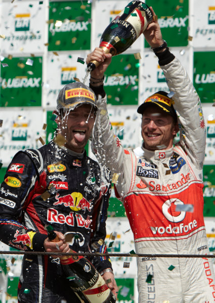 Interlagos, Sao Paulo, Brazil.
27th November 2011.
Jenson Button, McLaren MP4-26 Mercedes, 3rd position, gives Mark Webber, Red Bull Racing RB7 Renault, 1st position, a soaking on the podium. Portrait. Podium. 
World Copyright: Steve Etherington/LAT Photographic
ref: Digital Image SNE28386