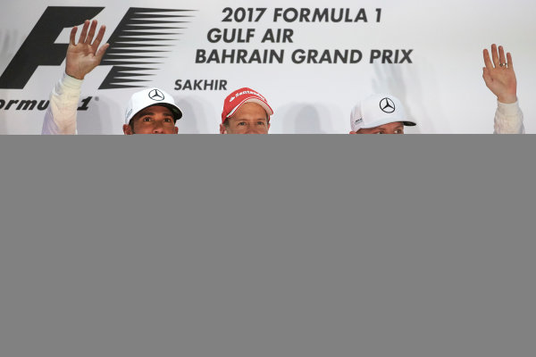 Bahrain International Circuit, Sakhir, Bahrain. 
Sunday 16 April 2017.
Lewis Hamilton, Mercedes AMG, 2nd Position, Sebastian Vettel, Ferrari, 1st Position, and Valtteri Bottas, Mercedes AMG, 3rd Position, on the podium.
World Copyright: Steve Etherington/LAT Images
ref: Digital Image SNE23058