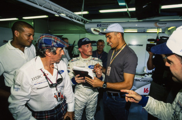 Johnny Herbert meets Brazilian footballer Ronaldo in the garage with Jackie Stewart.