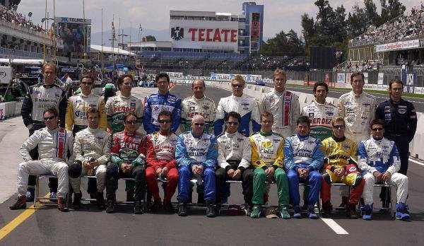 The Champ Car drivers pose for a photograph in the pitlane. Back row (L to R): Gualter Salles (BRA) Dale Coyne Racing, Rodolfo Lavin (MEX) Walker Racing, Mario Dominguez (MEX) Herdez Racing, Luis Diaz (MEX) Walker Racing, Roberto Moreno (BRA) Herdez Racing, Mika Salo (FIN) PK Racing, Ryan Hunter-Reay (USA) American Spirit Team Johansson, Roberto Gonzalez (MEX) Herdez Racing, Geoff Boss (USA) Dale Coyne Racing, Darren Manning (GBR) Walker Racing. Front row (L to R): Jimmy Vasser (USA) American Spirit Team Johansson, Tiago Monteiro (POR) Fittipaldi Dingman Racing, Adrian Fernandez (MEX) Fernandez Racing, Michel Jourdain Jr. (MEX) Team Rahal, Paul Tracy (CDN) Forsythe Racing, Bruno Junqueira (BRA) Newman Haas, Sebastien Bourdais (FRA) Newman Haas, Patrick Carpentier (CDN) Forsythe Racing, Mario Haberfeld (BRA) Conquest Racing, Alex Tagliani (CDN) Rocketsports Racing.
Champ Car World Series, Rd17, Mexico City, Mexico, 10-12 October 2003.
DIGITAL IMAGE