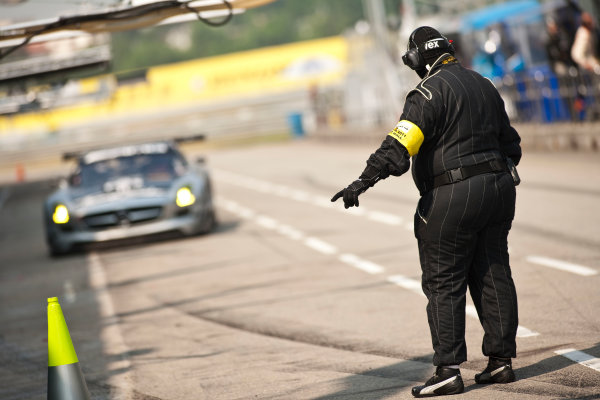 6 Hours of Zhuhai.
Zhuhai, China. 11th - 13th November 2011. 
A team member in the pits with the car of Mika Hakkinen / Cong Fu Cheng / Lance David Arnold, Team AMG China, Mercedes SLS AMG GT3. 
Atmosphere. 
Action. 
Drew Gibson/LAT Photographic. 
ref: Digital Image _Y2Z4494