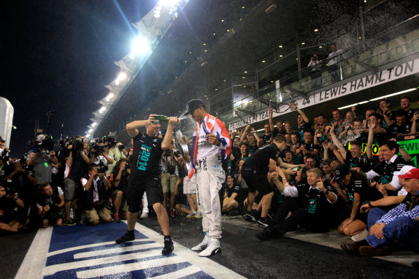 Yas Marina Circuit, Abu Dhabi, United Arab Emirates.
Sunday 23 November 2014.
Lewis Hamilton, Mercedes AMG, 1st Position, celebrates 2014 Championship victory with his team.
World Copyright: Andrew Ferraro/LAT Photographic.
ref: Digital Image _MG_1558