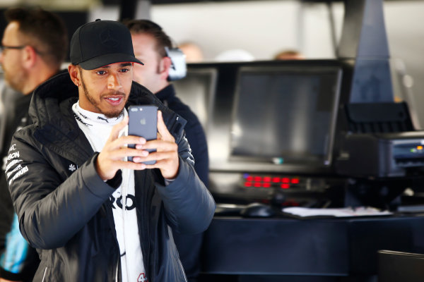 Shanghai International Circuit, Shanghai, China. 
Friday 07 April 2017.
Lewis Hamilton, Mercedes AMG, uses his phone in the garage during a weather delay in FP2.
World
World Copyright: Andy Hone/LAT Images
ref: Digital Image _ONY4122