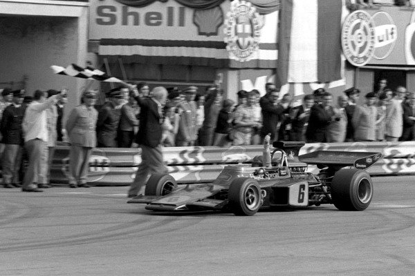 Emerson Fittipaldi, Lotus 72D Ford, celebrates victory and becoming world champion as he takes the chequered flag. Emerson Fittipaldi, Lotus 72D Ford, celebrates victory and becoming world champion as he takes the chequered flag.