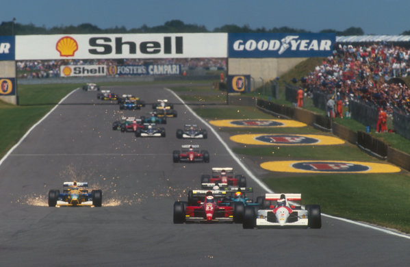 1991 British Grand Prix.
Silverstone, England.
12-14 July 1991.
Gerhard Berger (McLaren MP4/6 Honda) on the approach to Stowe at the start, with Alain Prost (Ferrari 643), Mauricio Gugelmin (Leyton House CG911 Ilmor), Stefano Modena (Tyrrell 020 Honda) and a super sparking Nelson Piquet (Benetton B191 Ford) following behind down Hangar Straight.
Ref-91 GB 10.
World Copyright - LAT Photographic



