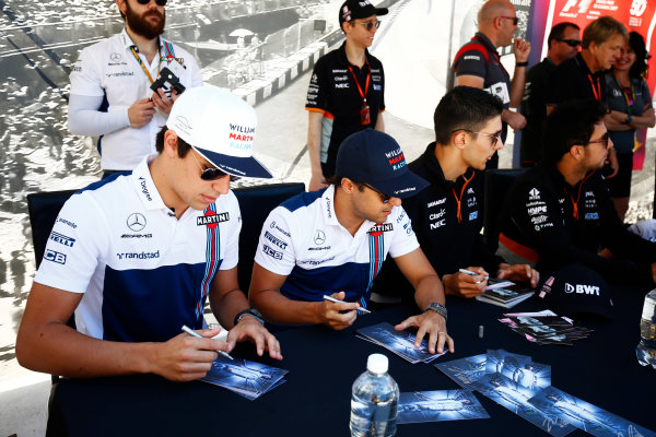 Circuit Gilles Villeneuve, Montreal, Canada.
Thursday 08 June 2017.
Lance Stroll, Williams Martini Racing, and Felipe Massa, Williams Martini Racing, sign autographs for fans, alongside Esteban Ocon, Force India, and Sergio Perez, Force India. 
World Copyright: Andy Hone/LAT Images
ref: Digital Image _ONZ9799