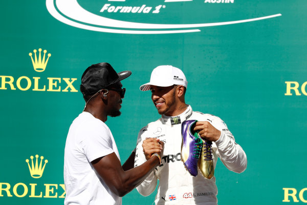 Circuit of the Americas, Austin, Texas, United States of America.
Sunday 22 October 2017.
Usain Bolt presents Lewis Hamilton, Mercedes AMG, 1st Position, with a pair of his running shoes.
World Copyright: Glenn Dunbar/LAT Images 
ref: Digital Image _31I5692